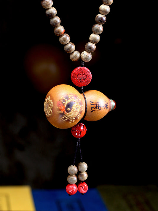 This item is crafted with a base of natural Agarwood, known for its elegant and spirit-nourishing properties. It is accented with beads of pure yang Cinnabar and a small, natural gourd, creating a personal ritual object that combines aromatic healing with spiritual protection.